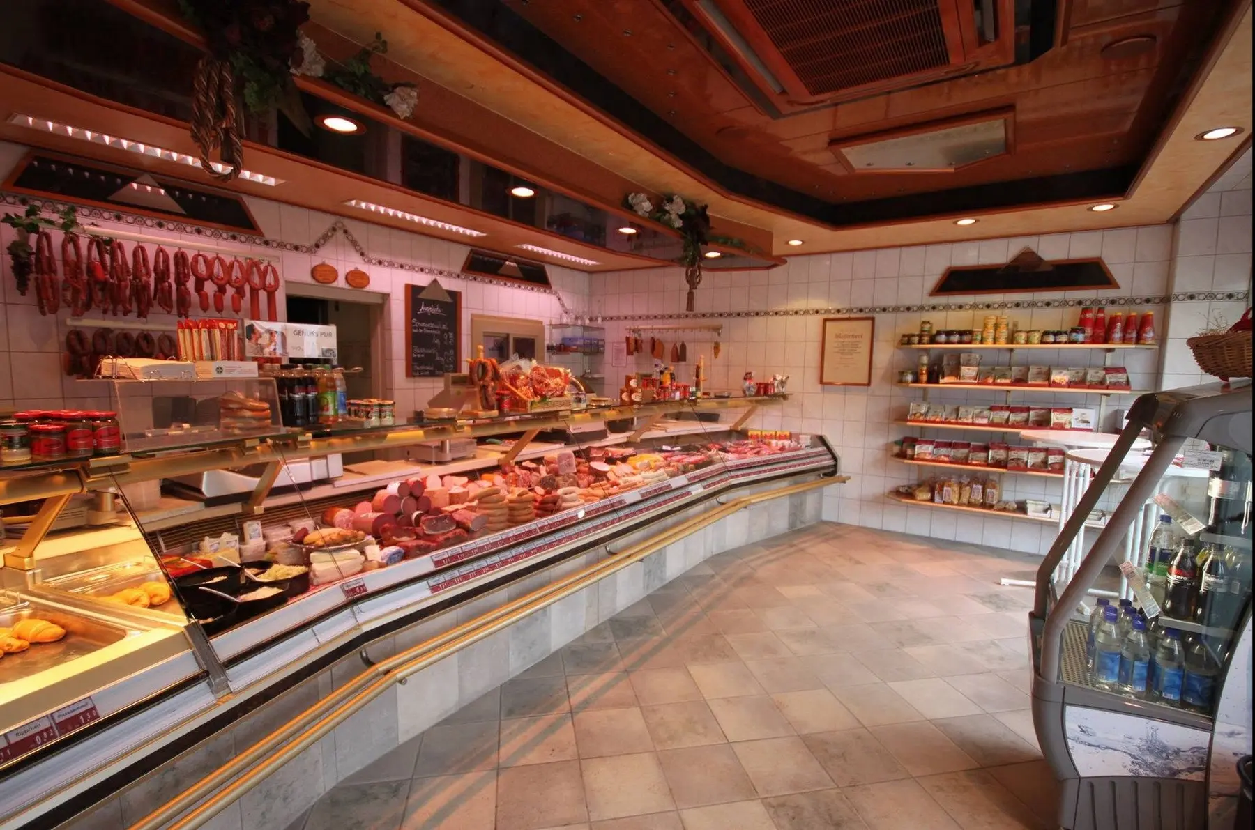Blick in den Verkaufsraum der Metzgerei Kotzurek – warme Holzdecke, Fleisch- und Wursttheke